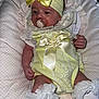 Talia-Louise is registered to the contest to win money with this photo: baby, infant, pacifier, yellow_bow, headband, white_socks, frills, seat, blanket, clothing, cute, small_hands, portrait, indoors, child, resting, soft_texture, decorative, person, newborn