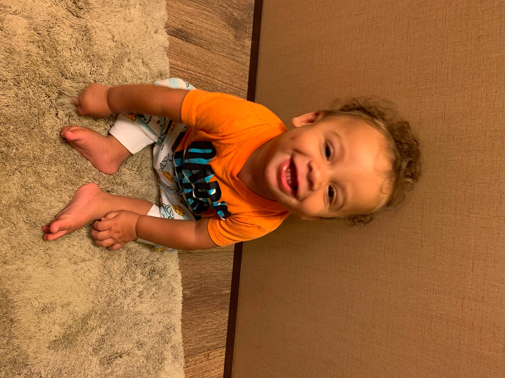 Loki is registered to the contest to win money with this photo: child, elbow, eye, face, finger, flooring, fun, happy, human_body, human_leg, leisure, nose, person, play, skin, smile, t_shirt, toddler, tree, window