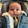 baby, infant, denim_jacket, car_seat, pacifier, fur_lining, clothing, child, cute, portrait, indoor, seated, young_child, face, head, eyes, expression, warm_clothes, comfort, casual