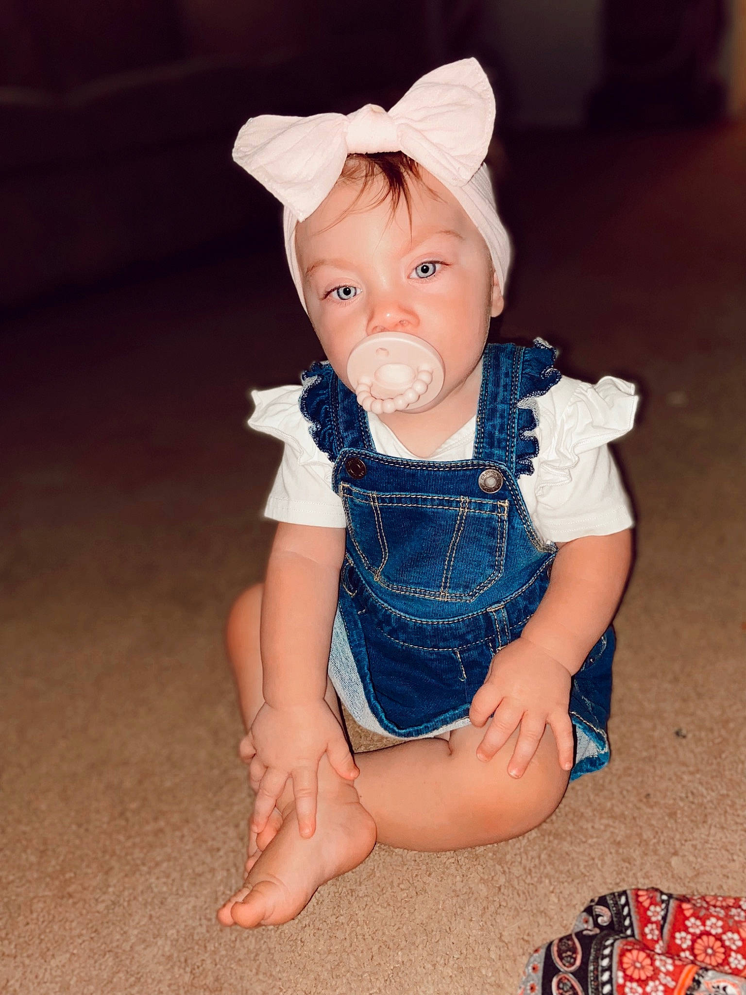 Mia Grace is registered to the contest to win money with this photo: baby, baby_toddler_clothing, child, dress, ear, electric_blue, eye, fawn, foot, fun, fur, head, human_leg, pattern, peach, person, sitting, skin, sleeve, toddler