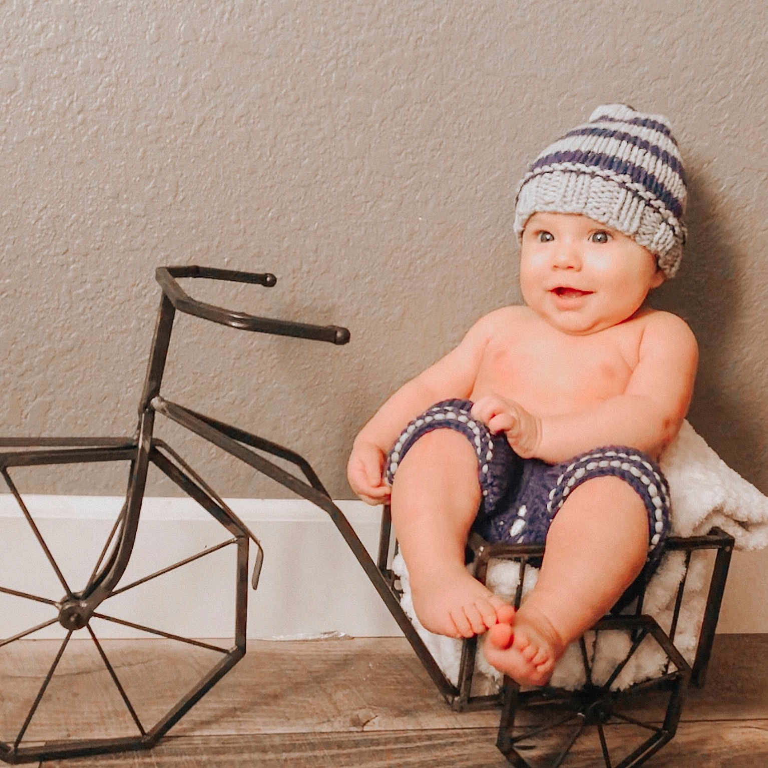 A.j. is registered to the contest to win money with this photo: baby, beanie, cap, chair, child, child_model, furniture, headgear, headwear, leg, person, photography, sitting, skin, toddler, vehicle