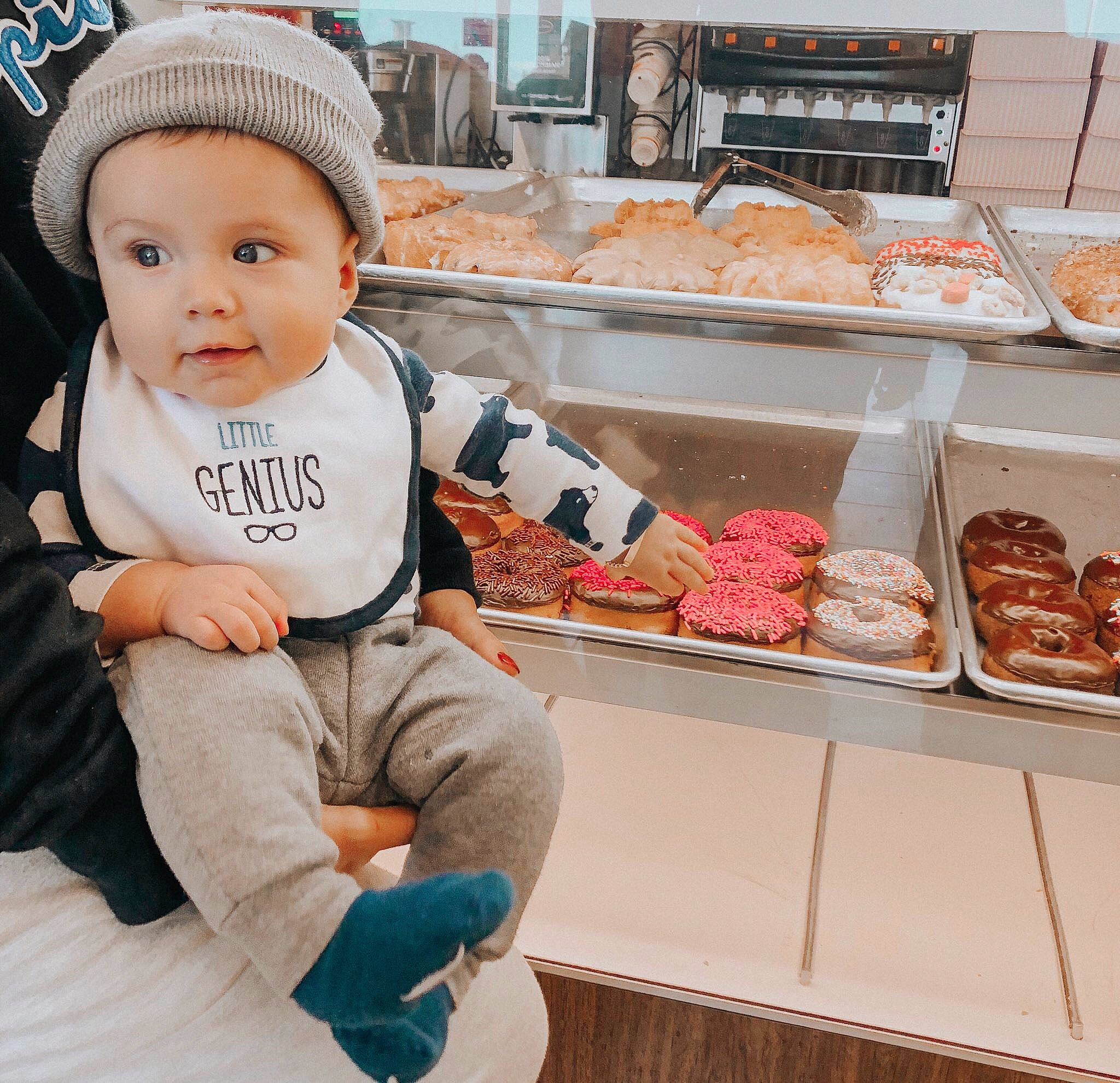 A.j. is registered to the contest to win money with this photo: baby, bakery, beanie, cap, child, cuisine, food, headgear, outerwear, person, pink, snack, t_shirt, toddler