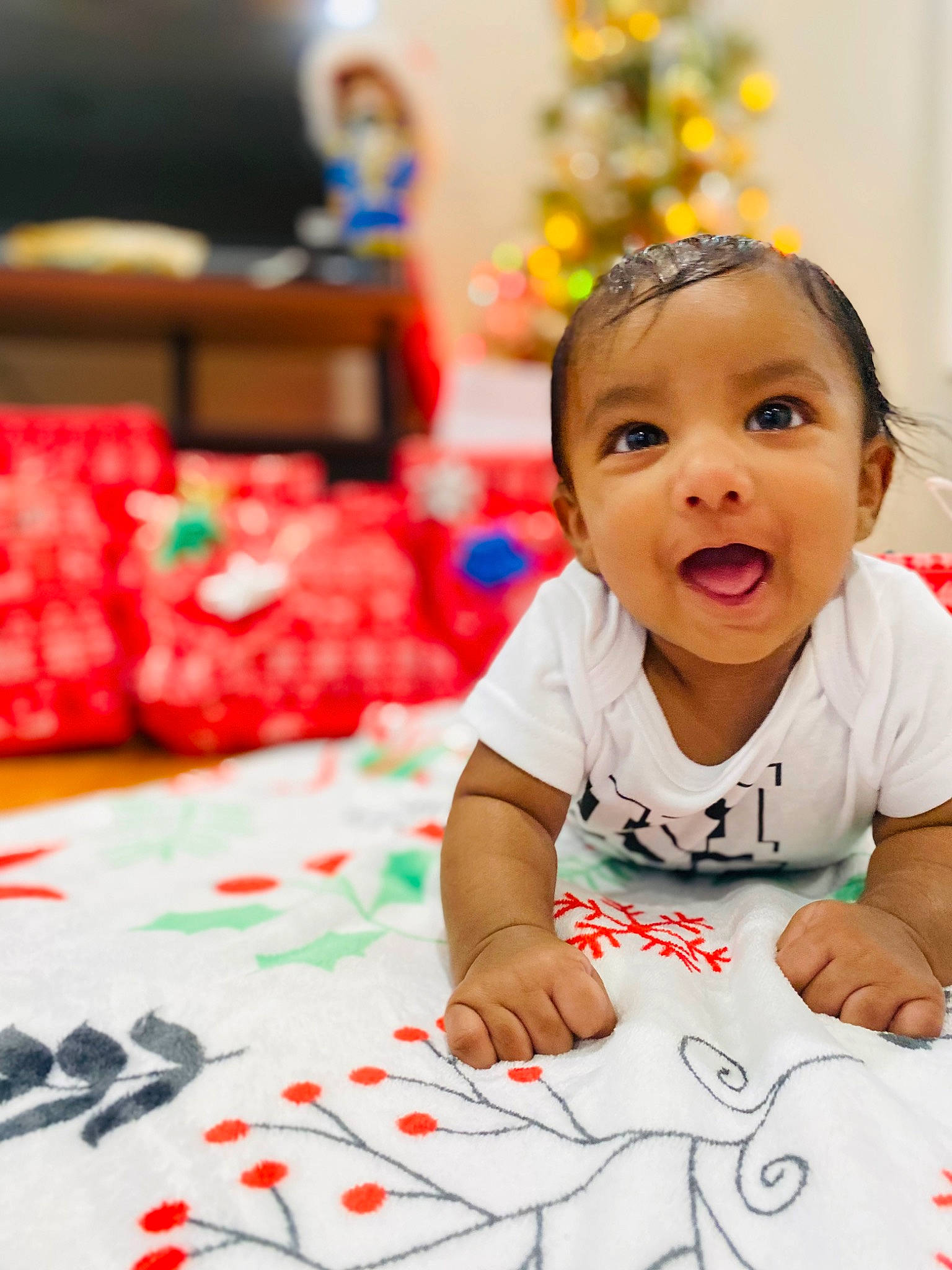 Chris joined the competition — help win amazing prizes! baby, baby_toddler_clothing, child, design, event, flooring, fun, happy, head, holiday, leisure, pattern, person, plant, play, red, sitting, skin, smile, surprise