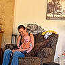 Jaxon joined the competition — help win amazing prizes! baby, woman, armchair, indoor, smile, bib, clothing, phone, couch, blanket, painting, wall, person, jeans, happy, furniture, relaxed, casual, home, seated