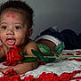 Aileon participe au concours pour gagner de l'argent avec cette photo : baby, infant, child, rose, flower, red_petals, petals, blanket, portrait, close_up, smile, curly_hair, face, eyes, lipstick_marks, kisses, skin, lying_down, soft_texture, indoor