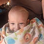 baby, blanket, animal_print, person, child, indoor, adult, face, smile, blue_eyes, earring, tank_top, skin, holding, comfort, warm, cute, closeup, seated, parent