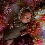 Edith is registered to the contest to win money with this photo: baby, infant, flower, paper_flower, bonnet, costume, portrait, cute, soft_lighting, floral_arrangement, child, newborn, decor, pastel_colors, resting, indoor, closeup, peaceful, skin, hands