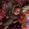 baby, infant, flower, paper_flower, bonnet, costume, portrait, cute, soft_lighting, floral_arrangement, child, newborn, decor, pastel_colors, resting, indoor, closeup, peaceful, skin, hands