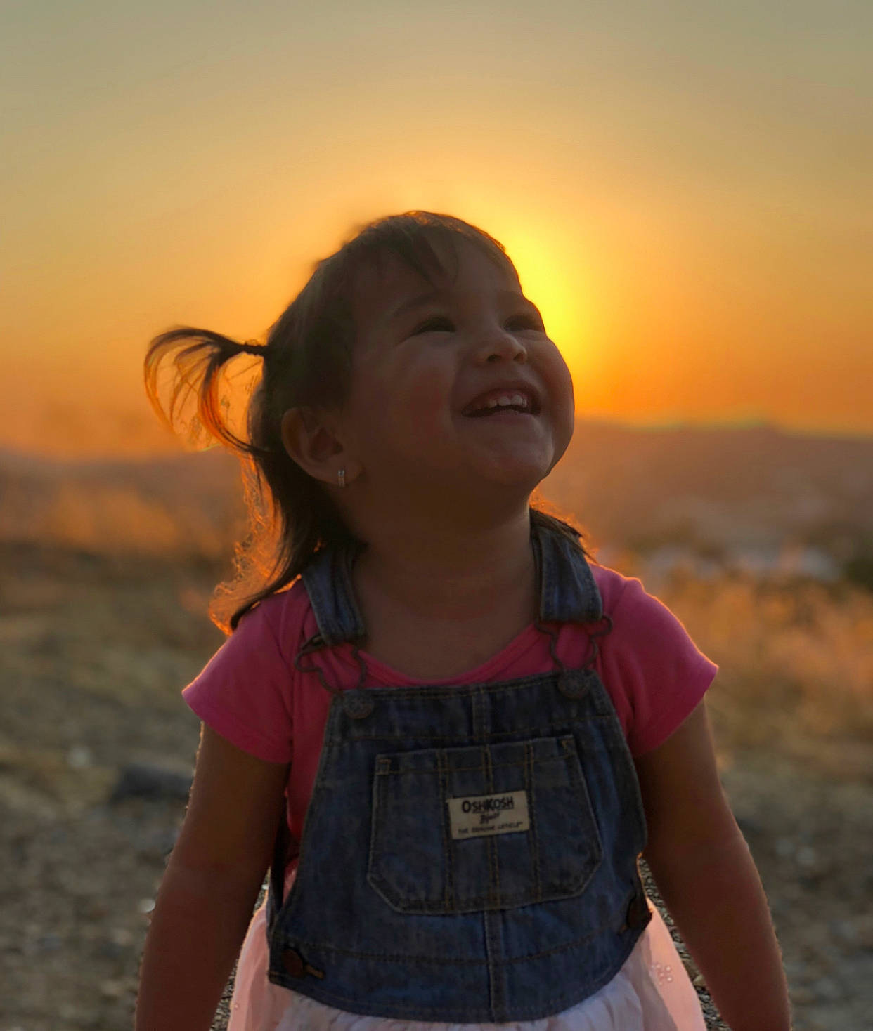 Jewel is registered to the contest to win money with this photo: child, evening, fawn, fun, happy, headwear, joy, landscape, person, photography, sky, smile, sunlight, sunset, travel, vacation