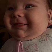 Hope is registered to the contest to win money with this photo: baby, close_up, smile, onesie, animal_print, cute, chubby_cheeks, infant, portrait, face, earring, happy, soft_lighting, indoors, child, young_baby, clothing, expression, head, skin