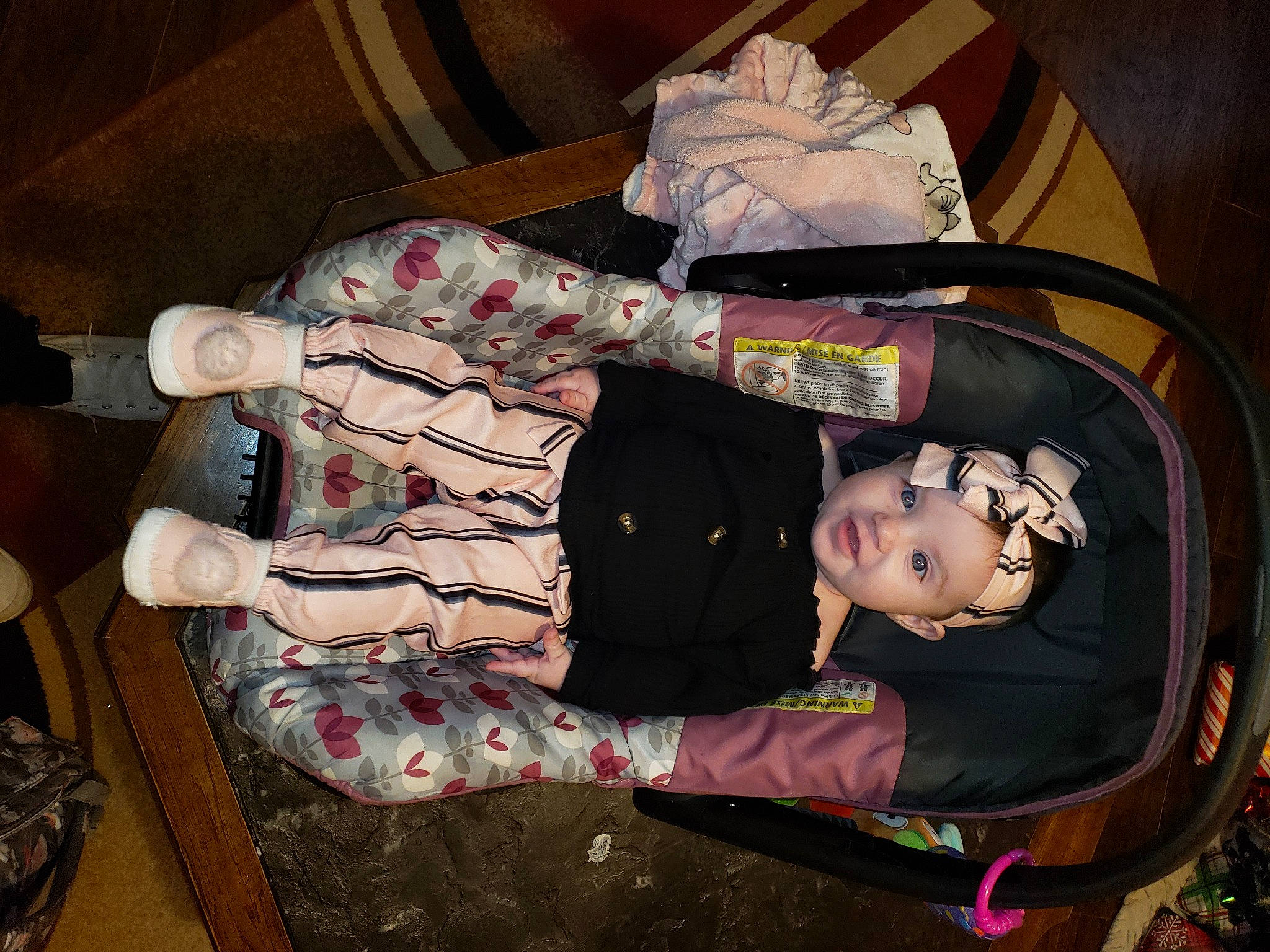 Emerson is registered to the contest to win money with this photo: baby, baby_products, baby_toddler_clothing, bag, child, comfort, flooring, hardwood, headwear, lap, luggage_and_bags, person, room, sitting, sleeve, toddler, walking_shoe