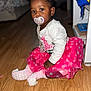 toddler, child, pacifier, pink_skirt, polka_dots, white_shirt, sitting, wooden_floor, indoor, cute, hair_puffs, socks, flooring, baby, portrait, young_child, clothing, earrings, focused, home