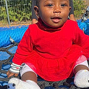 Larissa participe au concours pour gagner de l'argent avec cette photo : baby, blue_surface, child, clothing, cute, fence, happy, net, outdoor, person, playground, playing, red_dress, rope, smiling, socks, sunny, toddler, trees, young_child
