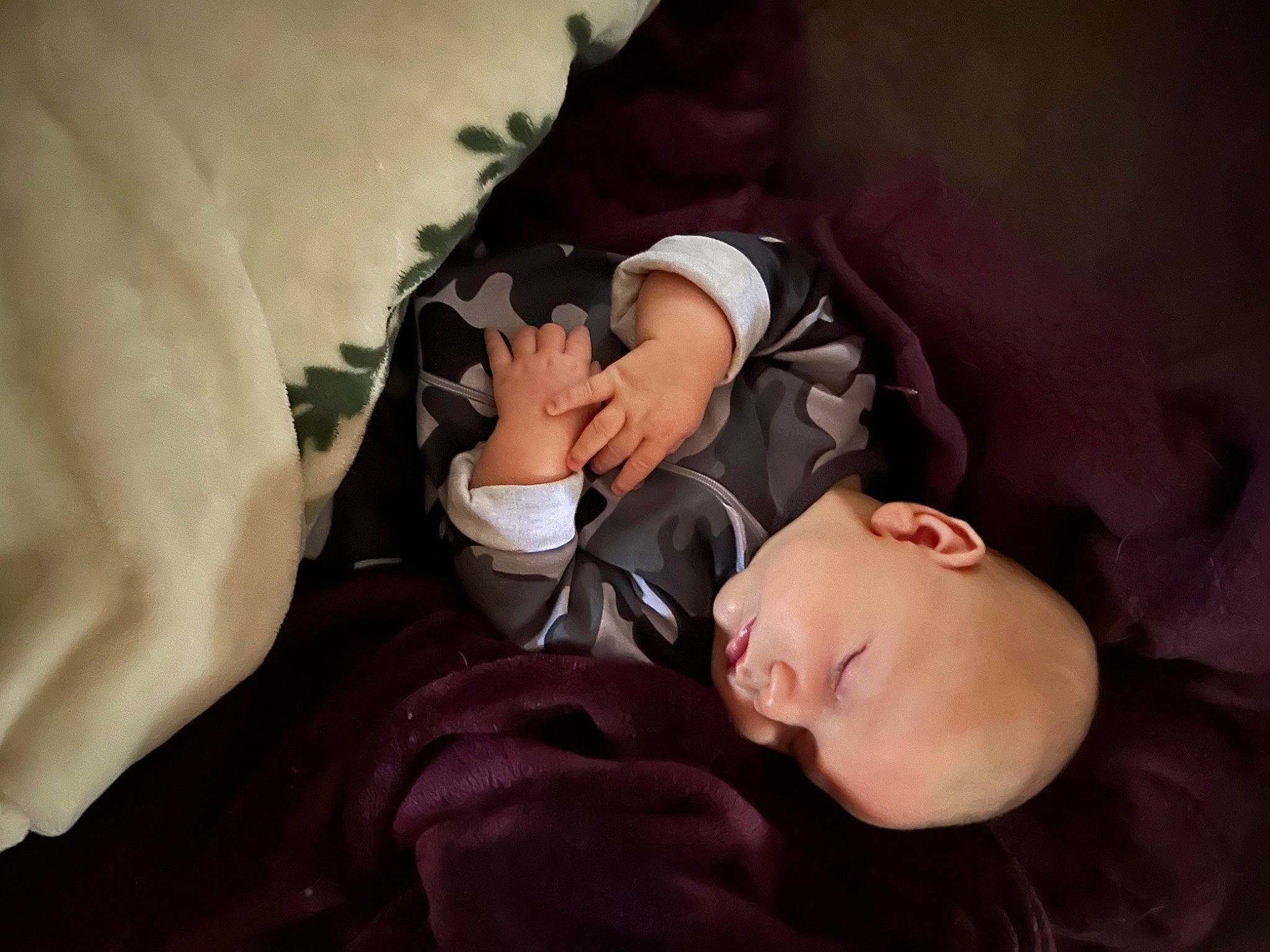 Knox is registered to the contest to win money with this photo: arm, baby, bedtime, cheek, child, comfort, ear, eyebrow, eyelash, finger, flash_photography, gesture, happy, linens, mouth, nail, person, sitting, textile, toddler