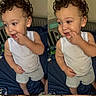 baby, bed, blue_bedspread, child, crib, curly_hair, cute, fingers_in_mouth, gray_shorts, home, indoor, person, playful, portrait, smiling, standing, toddler, two_images, white_tank_top, young_child