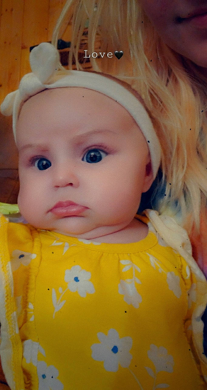 Natalei is registered to the contest to win money with this photo: baby, blond, cheek, child, doll, ear, eye, eyelash, face, forehead, hair_accessory, head, headwear, iris, lip, mouth, nose, person, skin, toddler