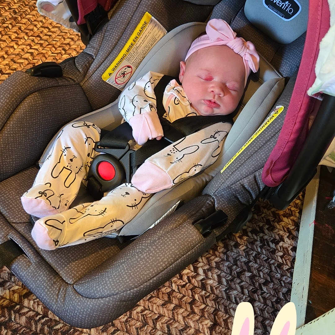 Lakelyn is registered to the contest to win money with this photo: baby, bed, car, car_interior, clothing, cushion, electronics, face, furniture, hat, head, homedecor, newborn, person, photography, portrait, sleeping, stroller, transportation, vehicle