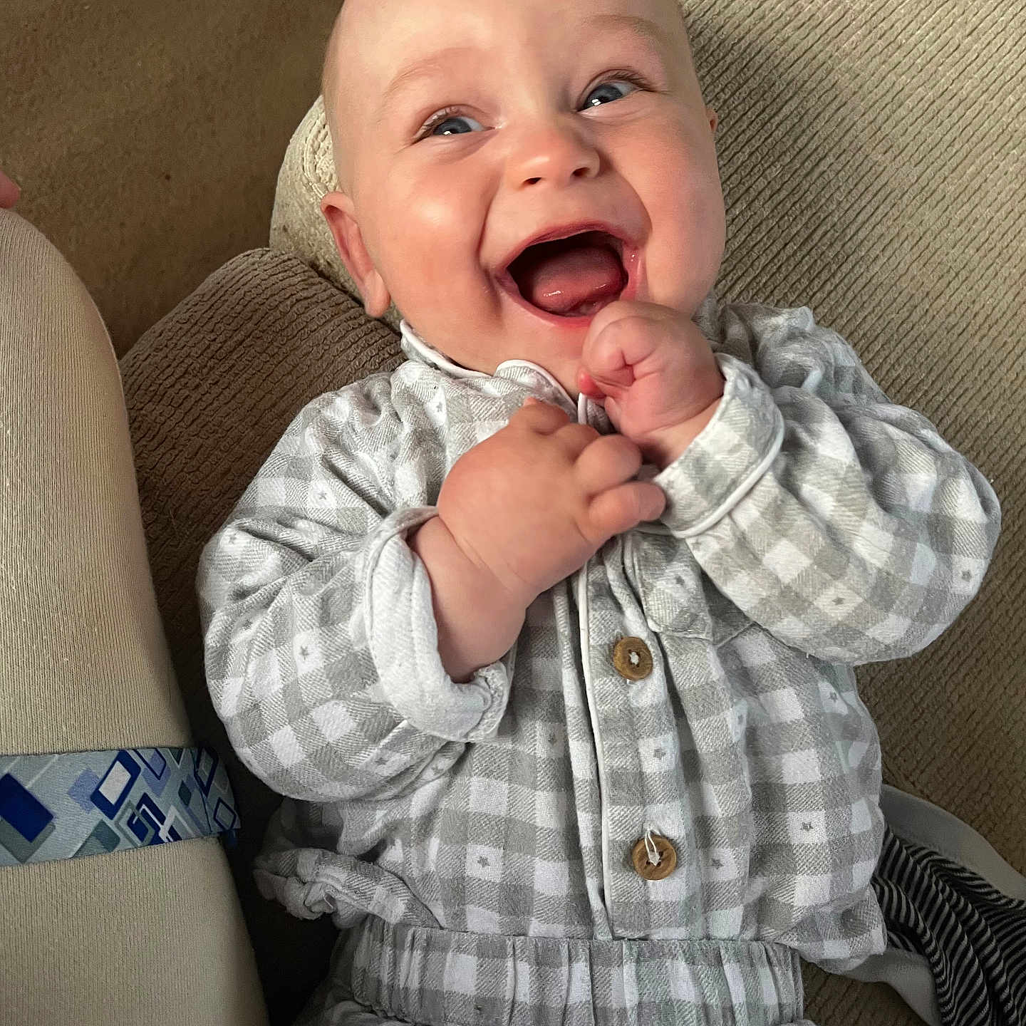 Forrest is registered to the contest to win money with this photo: baby, babylaughing, clothing, coat, couch, face, furniture, happy, head, jacket, laughing, pants, person, photography, portrait, shirt, smile, tape