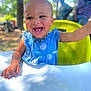 toddler, child, smiling, happy, blue_dress, beaded_necklace, yellow_chair, outdoor, sunlight, trees, portrait, table, hand, face, cute, baby, nature, daylight, person, fun