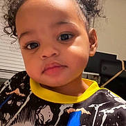 Leilani joined the competition — help win amazing prizes! toddler, child, curly_hair, indoor, portrait, superhero_shirt, face, young_child, black_hair, cute, casual_clothing, expression, person, home, blouse, smiling, closeup, eyebrows, eyelashes, skin