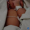 newborn, baby, infant, blanket, hospital, wristband, hat, sleeping, candid, closeup, soft_light, wrapped, skin, person, resting, young_child, indoors, peaceful, cute, portrait