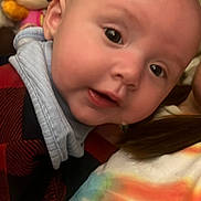 Fraeya joined the competition — help win amazing prizes! baby, child, face, closeup, indoor, toy, stuffed_animal, plush, person, apparel, colorful, curious, young_child, portrait, head, expression, cuddly, soft_toy, red, blue