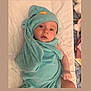 baby, infant, towel, blue_towel, blanket, bed, cute, face, eyes, headwear, child, soft_texture, wrapped, lying_down, indoors, newborn, expression, skin, hood, comfort