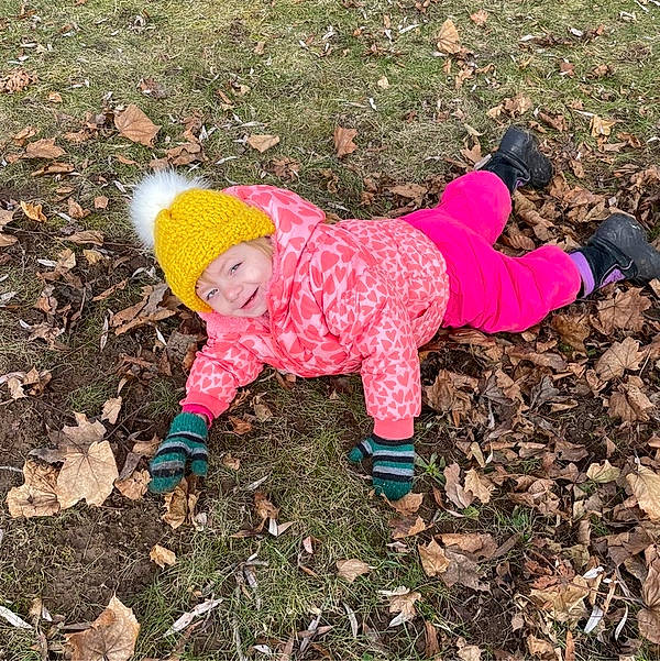 Lucy joined the competition — help win amazing prizes! baby_toddler_clothing, beanie, cap, carmine, child, glove, grass, happy, hat, headgear, headwear, knit_cap, magenta, pattern, people_in_nature, person, personal_protective_equipment, plant, play, sleeve