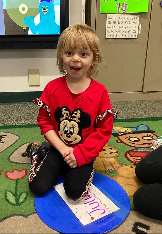 Juilana joined the competition — help win amazing prizes! carmine, child, flooring, fun, green, happy, knee, leisure, mammal, person, picture_frame, play, recreation, room, sitting, sleeve, smile, t_shirt, thigh, toddler