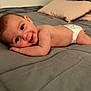 Kaycee is registered to the contest to win money with this photo: baby, diaper, bed, pillow, blanket, smile, face, skin, child, infant, lying_down, happy, indoor, cozy, young, person, head, cute, resting, soft