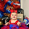 baby, child, smiling, portrait, indoors, costume, tutu, dress, red, blue, bow, superhero, spiderman, toys, helmet, playroom, birthday, happy, sitting, colorful