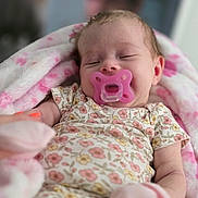 Kayla joined the competition — help win amazing prizes! baby, pacifier, blanket, sleeping, infant, pink, floral_outfit, soft_texture, cute, child, closeup, cozy, newborn, indoors, person, relaxing, comfort, tiny, adorable, peaceful