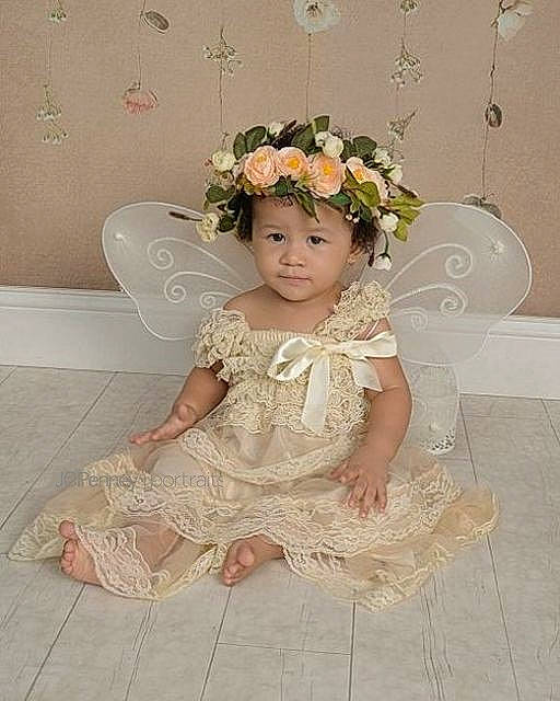 Abella is registered to the contest to win money with this photo: bridal_clothing, bride, child, dress, embellishment, flooring, flower, flower_girl, girl, gown, hair_accessory, headpiece, headwear, infant, lace, material, person, sitting, textile, toddler