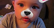 Camilla joined the competition — help win amazing prizes! toddler, child, indoor, face_filter, dog_ears, dog_nose, pink_hearts, curly_hair, gray_shirt, expression, reaching_hand, closeup, person, cute, soft_lighting, portrait, young_child, casual_clothing, playful, technology