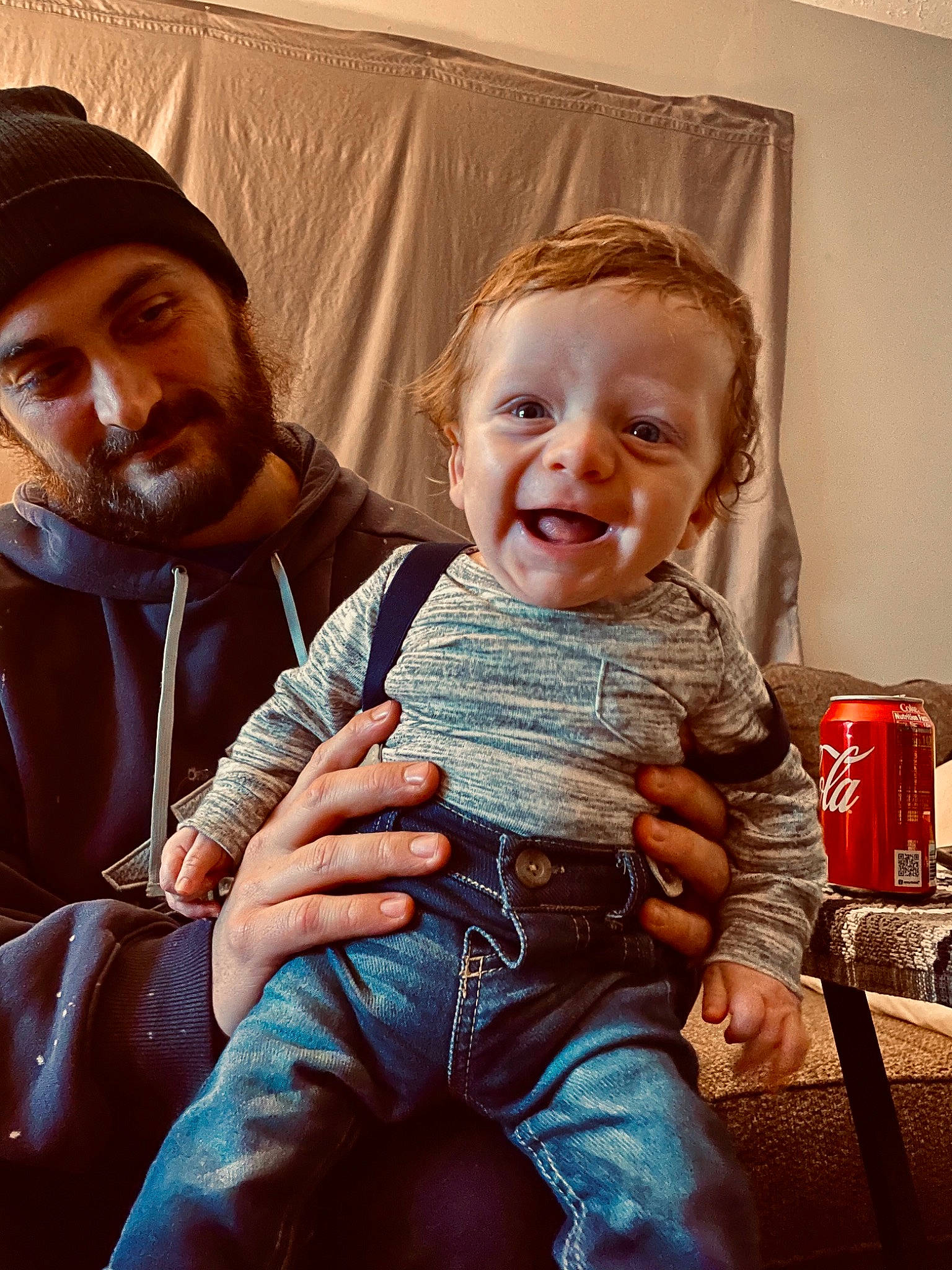 Daxx joined the competition — help win amazing prizes! baby, beard, cap, carbonated_soft_drinks, child, fun, gesture, happy, hat, head, headwear, human, jeans, joy, lap, moustache, person, sitting, skin, smile