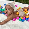 baby, infant, knit_hat, knit_diaper_cover, colorful_eggs, plastic_eggs, white_blanket, outdoor, grass, cute, child, portrait, laying_down, expression, curious, spring, holiday, easter, playful, soft_texture