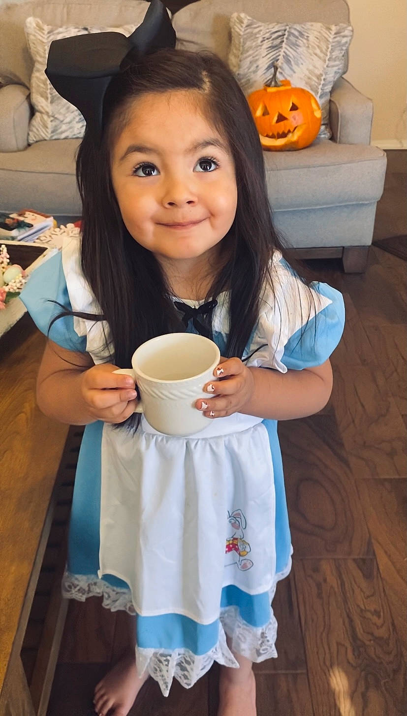 Lilliana is registered to the contest to win money with this photo: arm, calabaza, child, cucurbita, cup, drinking, drinkware, finger, flooring, food, gourd, hand, happy, joy, nail, person, pumpkin, shirt, smile, t_shirt