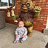 baby, child, infant, goblin, statue, portrait, sitting, outdoor, porch, brick_wall, pajamas, socks, wide_eyed, surprised, wicker_furniture, window, concrete_floor, fantasy_creature, bone_decoration, photography