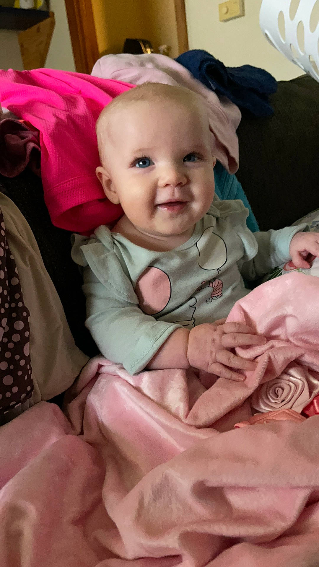 Phoebe is registered to the contest to win money with this photo: baby, baby_carriage, baby_safety, baby_toddler_clothing, cheek, child, chin, comfort, eye, eyebrow, head, iris, linens, mouth, person, pink, skin, sleeve, smile, textile