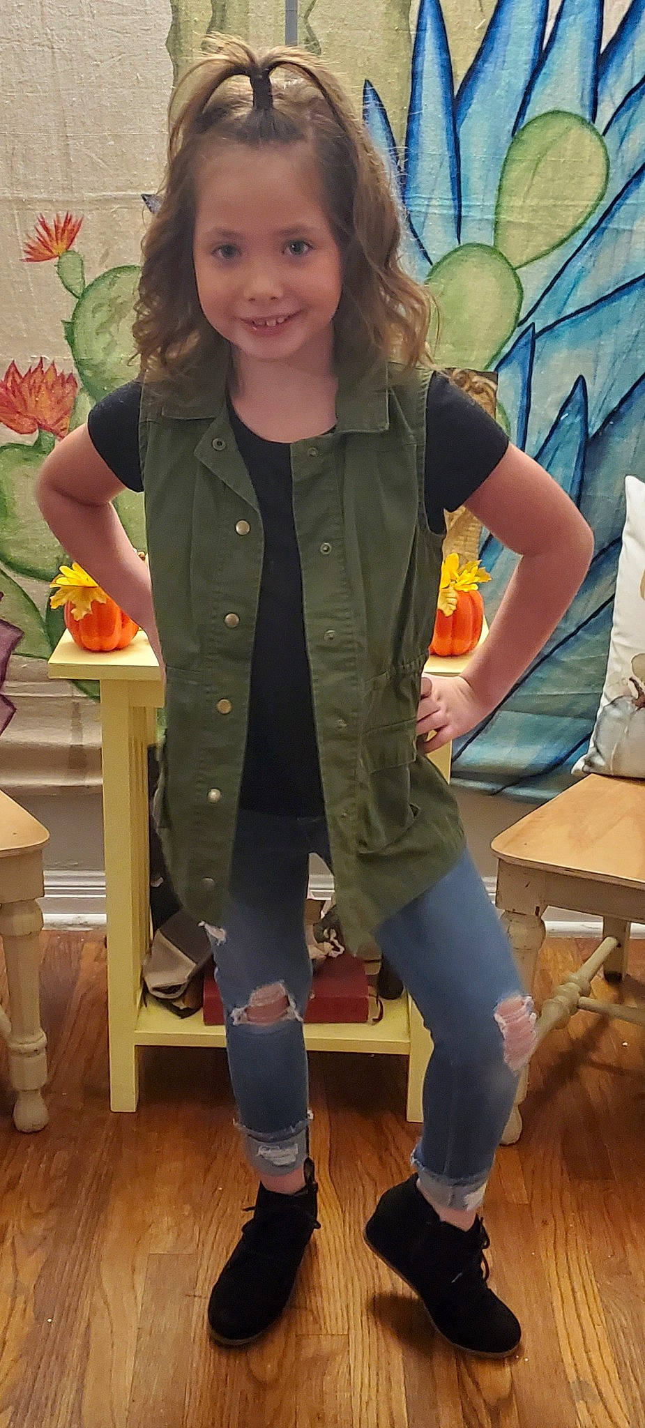 Blakeleigh is registered to the contest to win money with this photo: arm, brown_hair, child, child_model, clothing, costume, denim, footwear, jacket, jeans, joy, khaki, knee, leg, long_hair, outerwear, person, riding_boot, shoe, sleeve