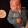 Hazel joined the competition — help win amazing prizes! baby, infant, child, smiling, portrait, denim_jacket, clothing, wooden_milestone, four_months, sitting, indoors, close_up, face, happy, casual, black_background, baby_photography, milestone, hand, fashion