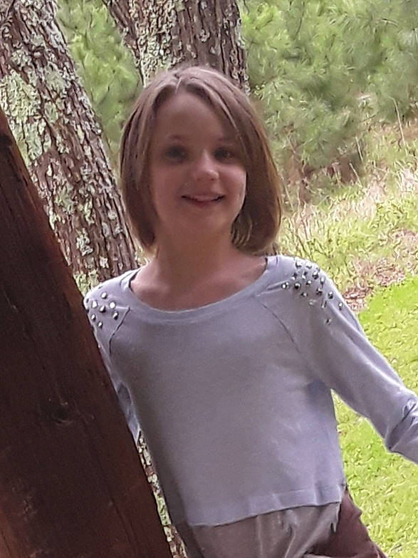 Alanna is registered to the contest to win money with this photo: cool, fun, grass, hair, happy, joy, leaf, long_hair, mammal, neck, people_in_nature, person, plant, shoulder, sleeve, smile, standing, tree, trunk, vertebrate