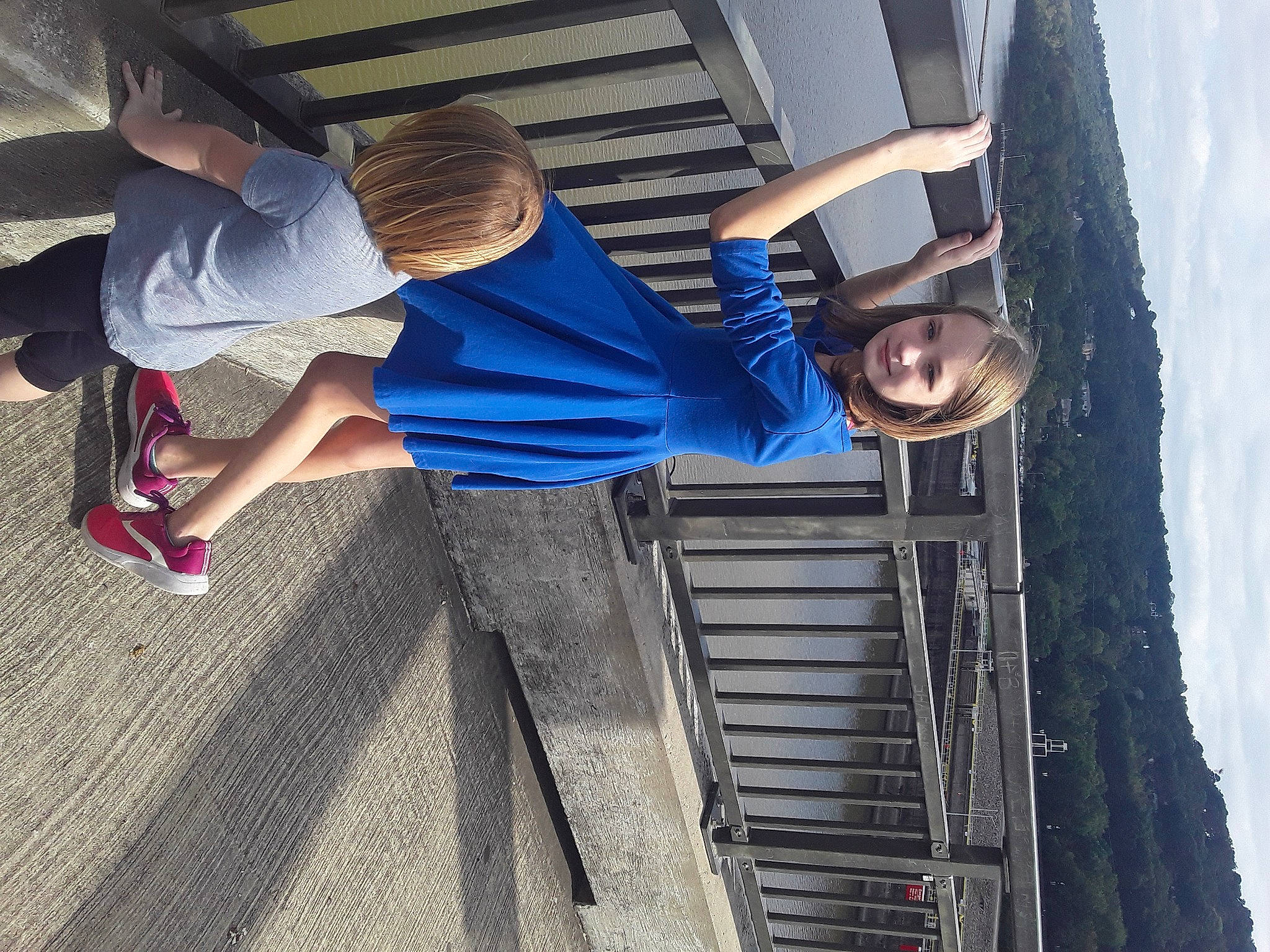 Alanna is registered to the contest to win money with this photo: azure, city, cool, denim, electric_blue, facade, footwear, fun, human_leg, joy, leg, leisure, pedestrian, person, shorts, sky, stairs, street_fashion, thigh, toddler