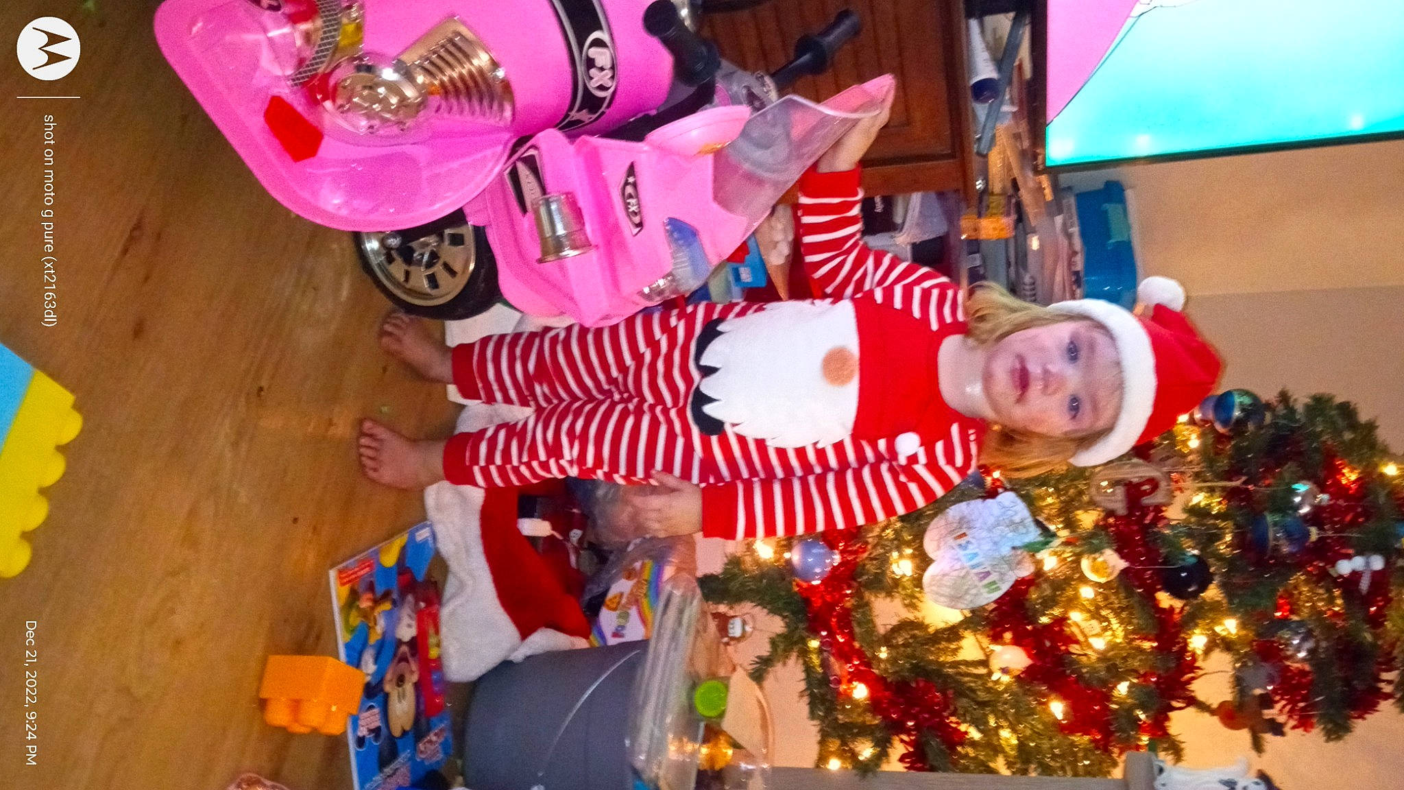 Gracelyn joined the competition — help win amazing prizes! christmas, christmas_decoration, christmas_eve, christmas_ornament, christmas_tree, decoration, event, fun, happy, hat, headwear, holiday, holiday_ornament, magenta, ornament, party_supply, person, red, room, santa_claus