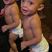 Zamir is registered to the contest to win money with this photo: toddlers, children, twins, smiling, standing, diapers, indoors, portrait, full_body, barefoot, wooden_floor, dark_rug, siblings, curious, happy, infants, home, people, photography, playful