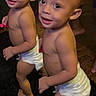 toddlers, children, twins, smiling, standing, diapers, indoors, portrait, full_body, barefoot, wooden_floor, dark_rug, siblings, curious, happy, infants, home, people, photography, playful