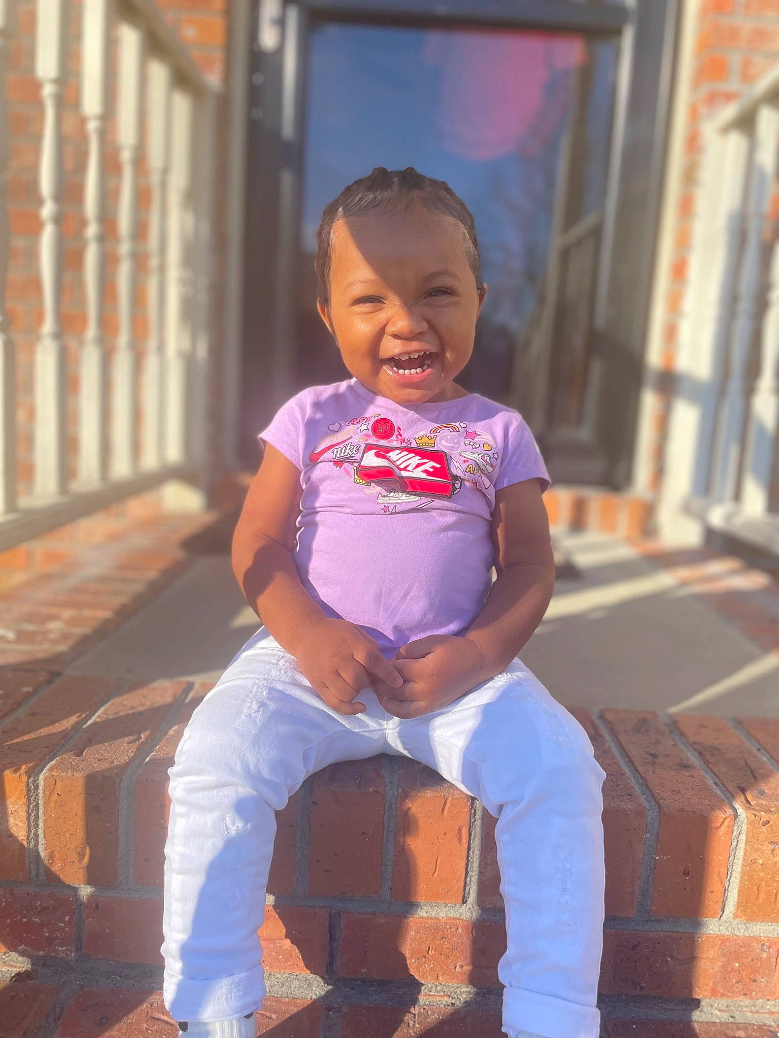 Amani is registered to the contest to win money with this photo: baby_toddler_clothing, child, denim, electric_blue, flooring, fun, happy, leg, leisure, magenta, person, sitting, sleeve, smile, standing, t_shirt, thigh, toddler, vacation, waist
