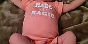 Tonya is registered to the contest to win money with this photo: baby, infant, onesie, blanket, legs, arms, feet, face, clothing, soft, lying_down, cute, sleepy, indoors, child, newborn, skin, person, expression, resting