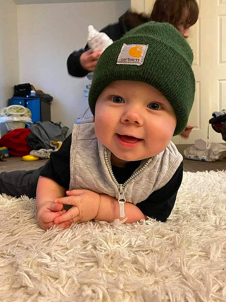 Lucius joined the competition — help win amazing prizes! baby, baby_toddler_clothing, cap, cheek, child, fashion_accessory, flooring, fun, grass, happy, headgear, headwear, knit_cap, people, person, sitting, skin, sleeve, smile, textile