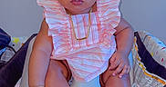 Mahari is registered to the contest to win money with this photo: baby, child, girl, playpen, pink_clothing, ruffles, gold_jewelry, hair_bow, indoor, poster, hello_kitty, friends, seated, cute, adorable, portrait, closeup, infant, face, expression